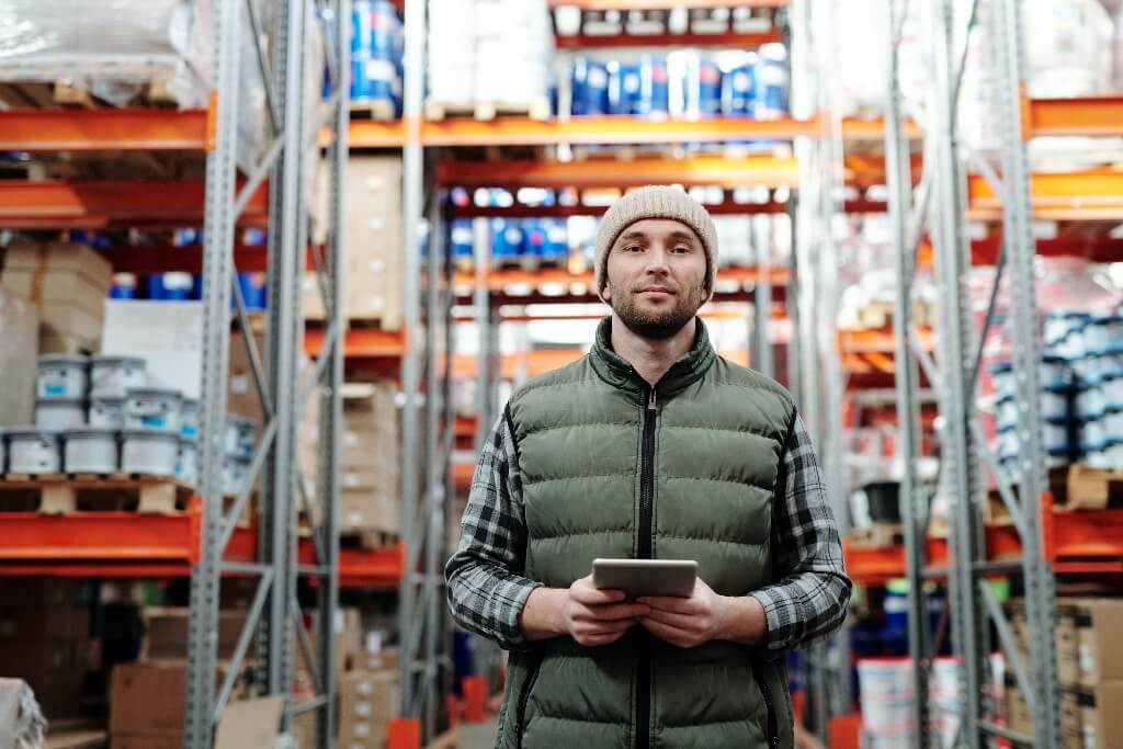 Man holding a tablet in a warehouse